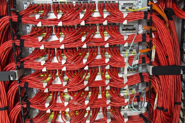 Bundles of data cables connect arrays of computer servers